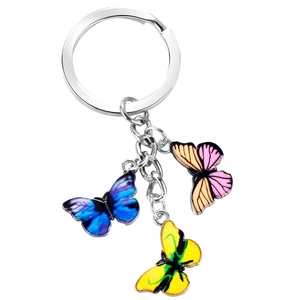 Detail of colorful butterfly pendants on a silver metal keychain with vibrant gradients