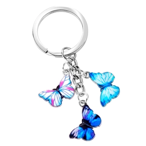 Detailed view of colorful butterfly pendants on a silver metal keychain with enamel coating