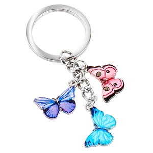Detailed view of silver keychain with three colorful butterfly charms and metal ring