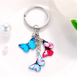 Colorful butterfly pendant keychain with blue and pink charms on a metal ring