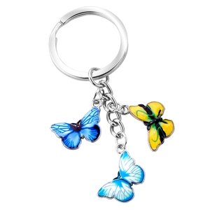 Detailed view of colorful butterfly charms on a silver metal keychain with three vibrant pendants