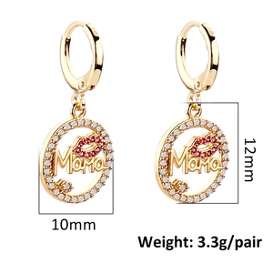 Detail showing 10mm Mama charm hoop earrings with red lip crystals and white stone inlay