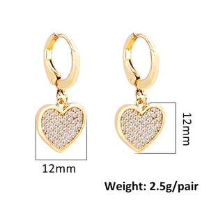 Detailed view of 12mm gold heart earrings with white crystals and lever back closure