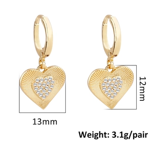 Detail view of gold heart earrings with zircon inlay and radial textures, size 13mm by 12mm