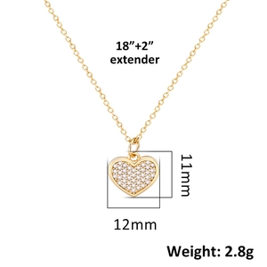 Detail shot of gold heart pendant with crystal pavé, showing dimensions 11mm x 12mm