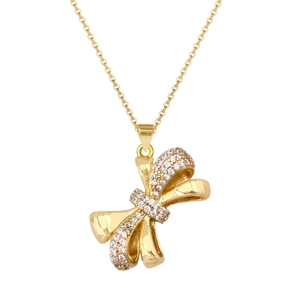 Macro detail of gold plated bow pendant necklace with micro pave cubic zirconia stones