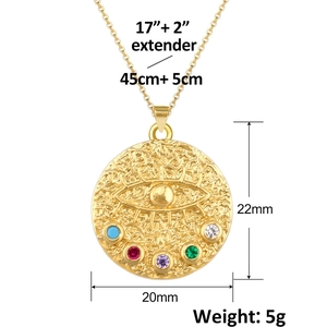 Macro shot of gold-plated evil eye pendant with hammer texture and colorful gemstones