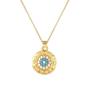 Detail of gold evil eye pendant with hammered texture and turquoise center stone