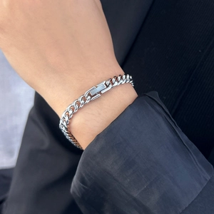 Detailed close-up of 6mm silver stainless steel Cuban link bracelet with secure clasp