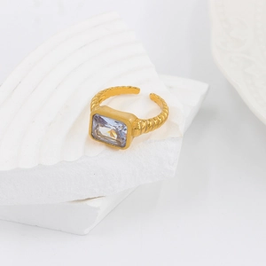 Detail of gold twisted band ring featuring a large rectangular zircon on stone