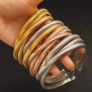 Detail of multi-layer snake chain chokers in gold, rose gold and silver finishes