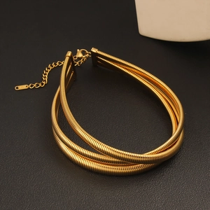 Detailed close-up of triple-layered gold snake chain choker with 18K lobster clasp