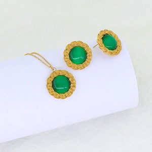 Detail view of gold woven rope necklace and earrings set with green turquoise inlay