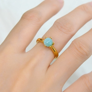 18K gold plated stainless steel ring with a round light blue gemstone in six-prong setting