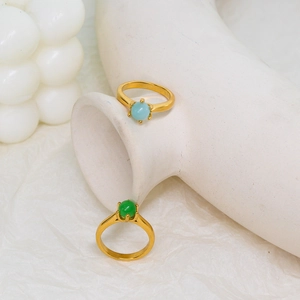 Detail of 18K gold plated stainless steel rings with blue and green gemstone inlay