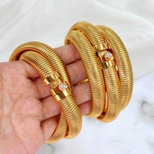 Gold spiral Tubogas snake bracelet with a crystal accented clasp for women
