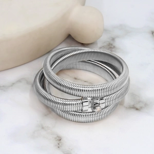 Macro detail of silver multi-layered snake bone bracelet with zircon square clasp