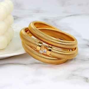 Macro shot of gold spiral Tubogas bracelet with central sparkling round zircon detail