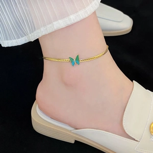 Elegant gold butterfly anklet for women featuring a blue-green enamel butterfly charm