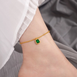 Minimalist gold titanium anklet with a square emerald zircon pendant on a fine chain