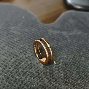 Detail of rose gold double-layered titanium ring with sparkling pave-set stones