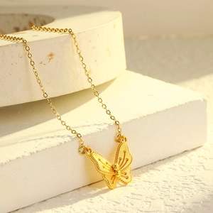 Elegant gold butterfly necklace in brushed titanium steel with fine textured wings