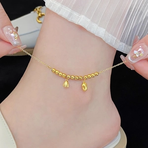 Gold anklet featuring lotus pod charms and polished beads on a dainty chain for women