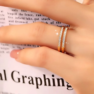 Detail of double-layer gold titanium steel ring with micro-paved sparkling cubic zirconia