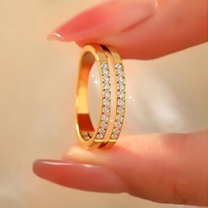 Detail of double-layer gold titanium steel ring with sparkling pavé-set zircons