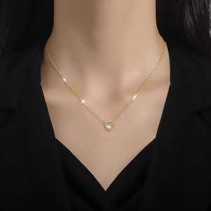 Magnifique collier en or avec pendentif cœur en zircone porté par un mannequin en col en V