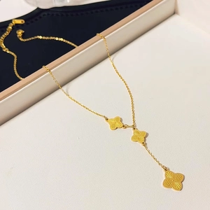 Elegant gold titanium steel necklace featuring three radial textured clover pendants