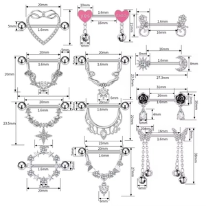Detailed macro view showing diverse zircon nipple rings with heart and snake designs
