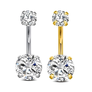 Primer plano de piercings de ombligo de acero inoxidable oro y plata con circonitas