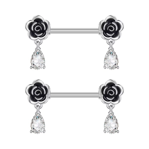 Detail of heart shape piercing jewelry with black rose and pear-cut zircon pendants