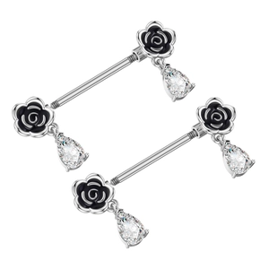 Detail view of heart-shaped zircon nipple barbells with black enamel rose and teardrop stone