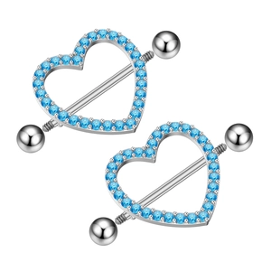 Close-up of heart-shaped nipple rings with blue zircon inlay and polished steel bars