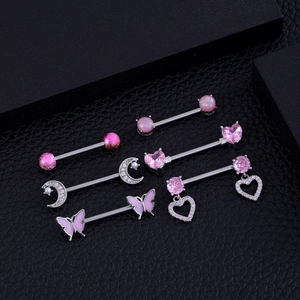 Detailed close-up of six pairs of pink zircon and heart-shaped stainless steel nipple rings