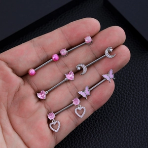 Detail of pink zircon and heart-shaped industrial barbell body piercing jewelry set