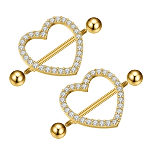 Close-up of golden heart-shaped nipple rings with sparkling cubic zirconia pavé