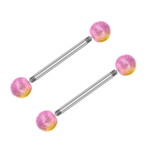 Macro detail of industrial barbell piercings with pink and yellow gradient textured balls