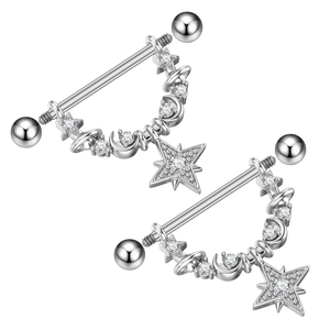 Macro shot of silver nipple barbells with star and moon charms and zircons