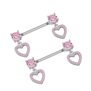Macro detail of silver nipple rings featuring pink heart-shaped zircon crystal dangles