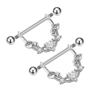 Macro detail of heart shaped nipple shields with zircon stones and rose floral designs