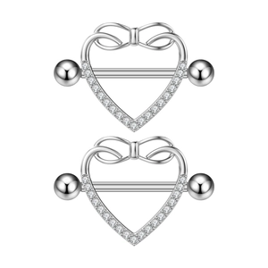 Macro shot of silver heart nipple rings with bowknot detail and sparkling zircons