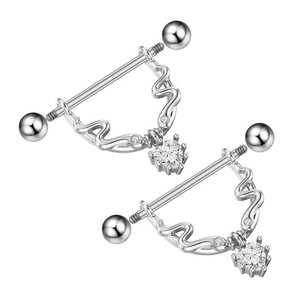 Macro detail of heart-shaped zircon nipple rings with polished steel barbell and pave gems
