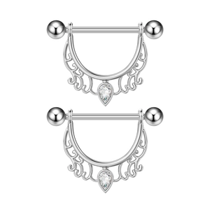 Detail view of heart-shaped nipple shields with teardrop zircon and scrollwork design
