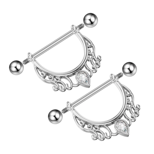 Detailed macro of silver nipple shields with pear-shaped cubic zirconia and hollow filigree