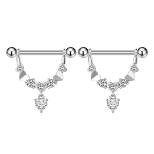 Macro detail of heart-shaped zircon nipple rings with polished stainless steel finish