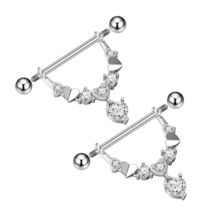 Detailed view of silver nipple rings with sparkling heart-shaped zircon and hollow accents