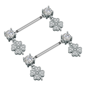 Macro detail of stainless steel nipple rings with zircon studs and clover charms